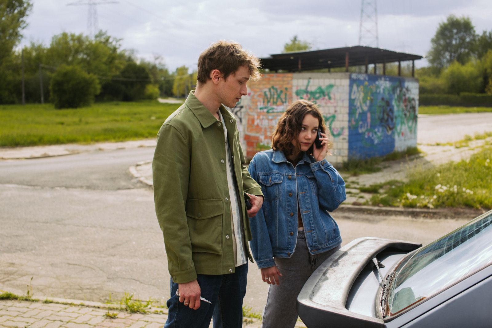 Couple beside their car on a roadside; auto club members can also use AAA member cruise deals