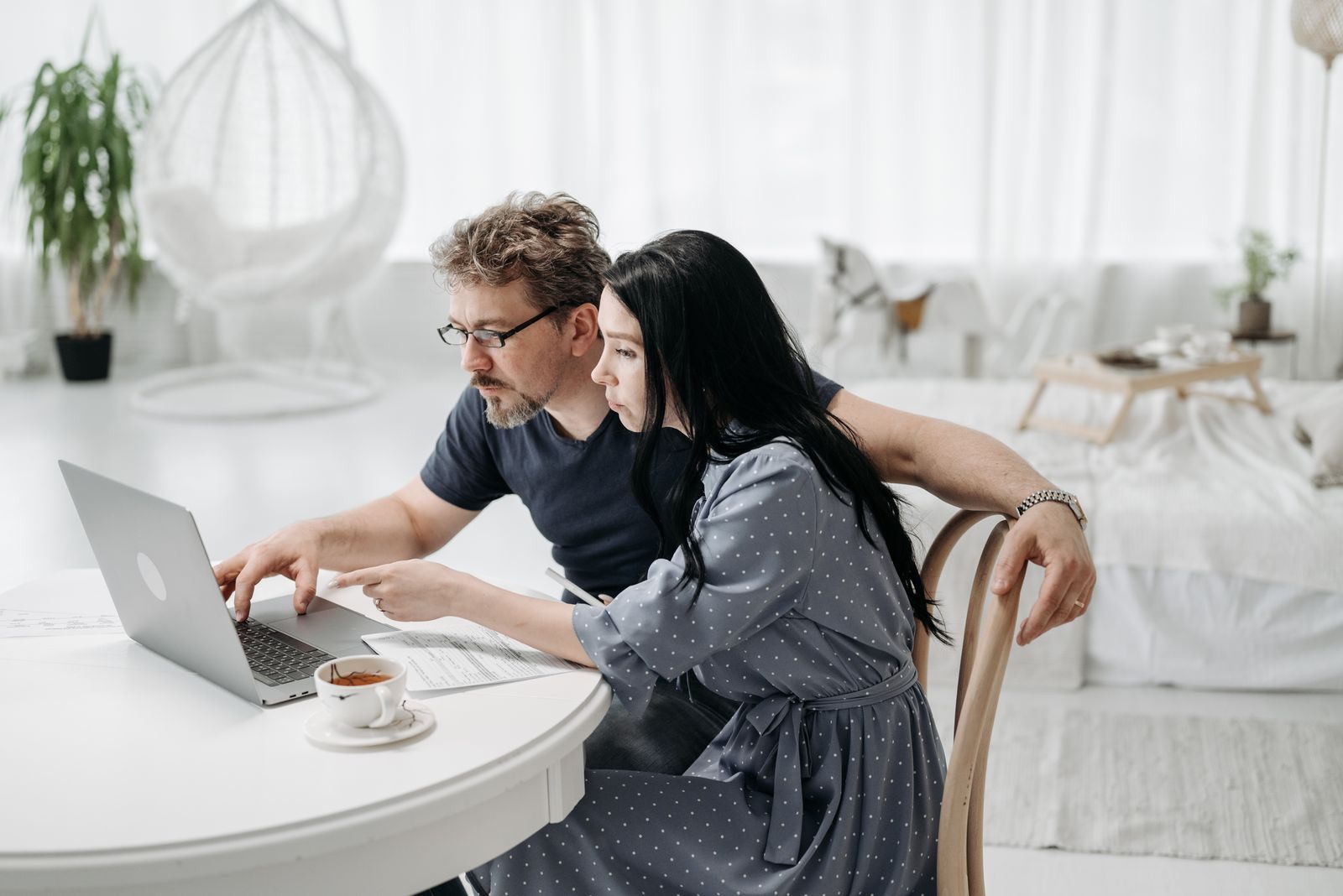 Man and woman planning a cruise together on a laptop at a table